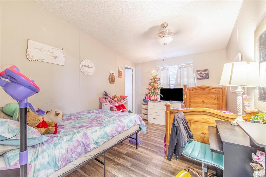2747 Old Bartow Road Lake Wales, FL 33859 - Photo 16 of 30 a bedroom with a bed and wooden floor