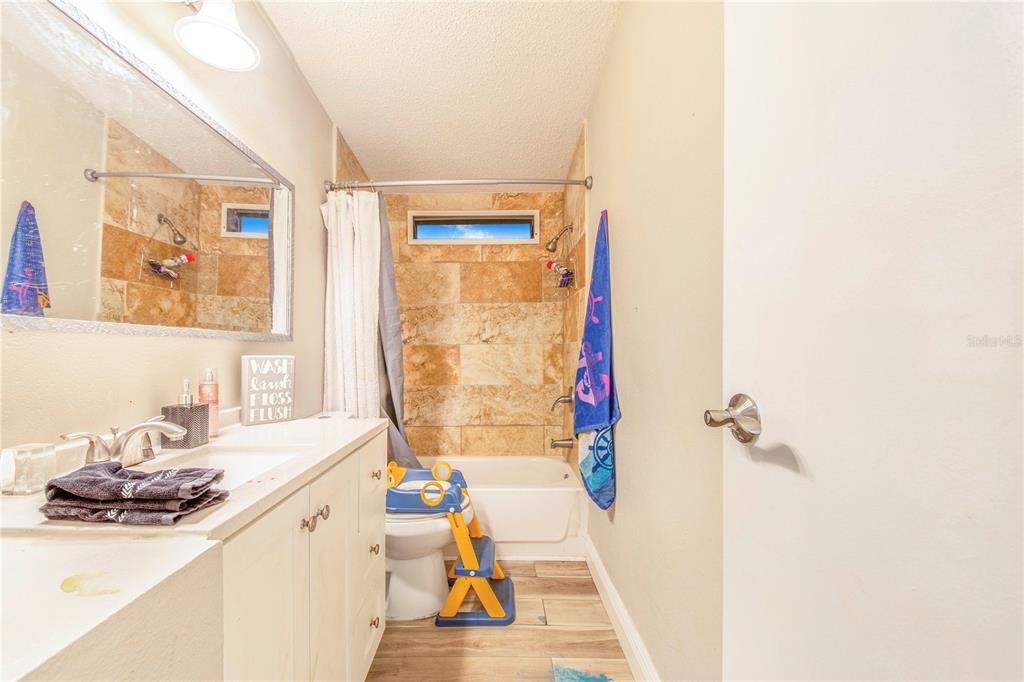 2747 Old Bartow Road Lake Wales, FL 33859 - Photo 17 of 30 a bathroom with a sink a mirror and a shower