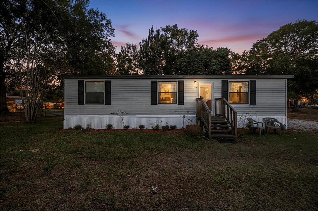 2747 Old Bartow Road Lake Wales, FL 33859 - Photo 19 of 30 a view of a backyard with plants and a tree