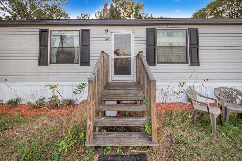 2747 Old Bartow Road Lake Wales, FL 33859 - Photo 3 of 30 front view of a house with a bench