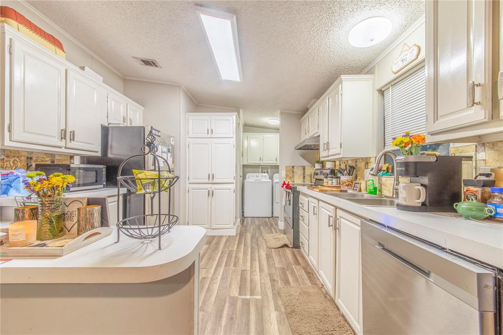 2747 Old Bartow Road Lake Wales, FL 33859 - Photo 10 of 30 a kitchen with a sink a stove top oven a refrigerator and a view of living room