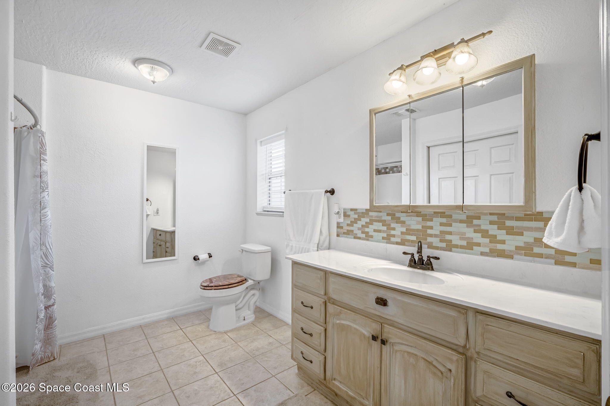 3404 Kilbee Street Mims, FL 32754 - Photo 17 of 30 a bathroom with a sink and a mirror