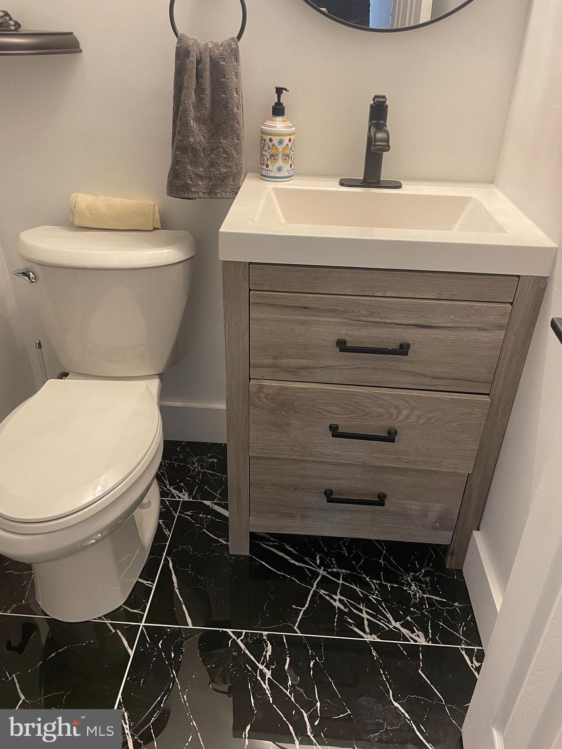 8917 Old Courthouse Road Vienna, VA 22182 - Photo 15 of 17 a bathroom with a toilet and a sink