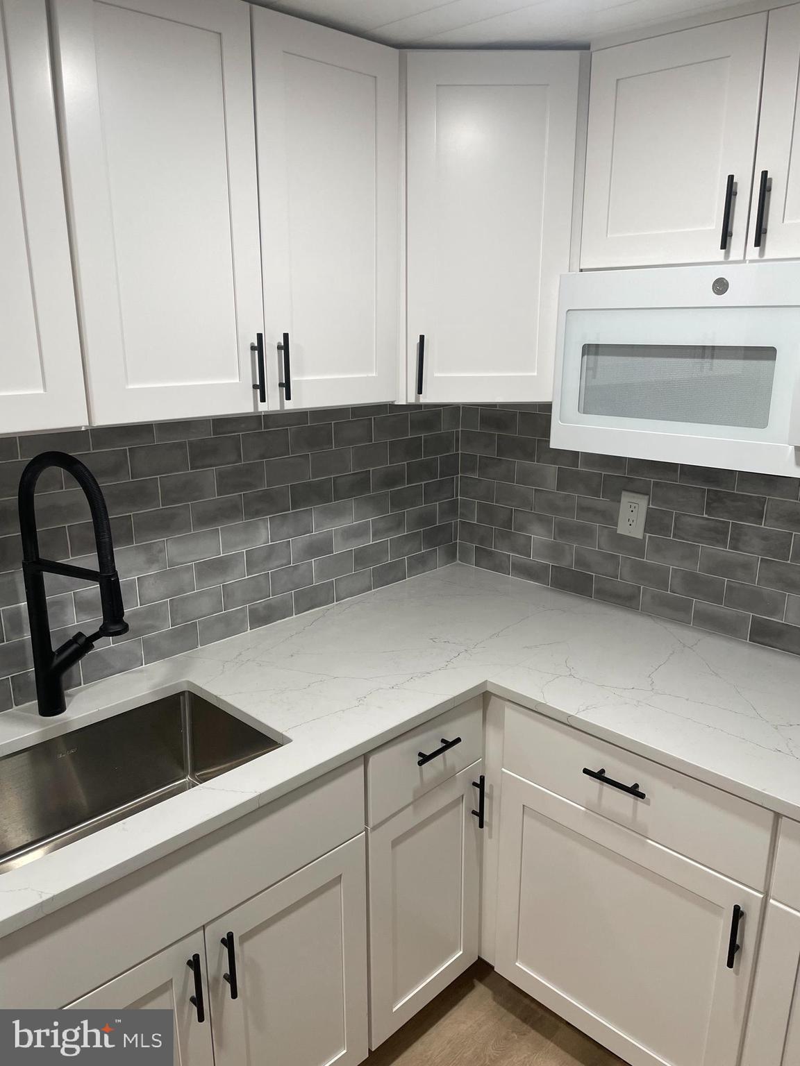 8917 Old Courthouse Road Vienna, VA 22182 - Photo 2 of 17 a kitchen with a sink and cabinets