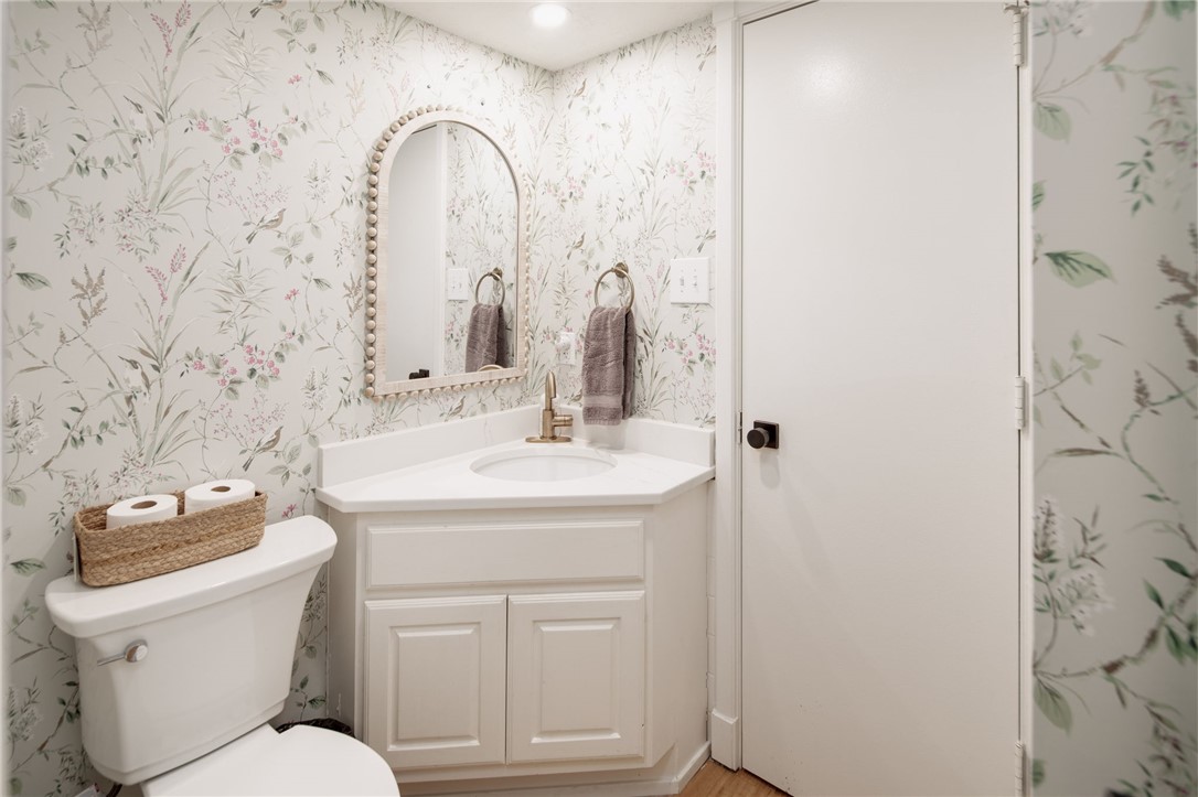 1015 East 24th Street Bryan, TX 77803 - Photo 18 of 43 a bathroom with a toilet sink and mirror