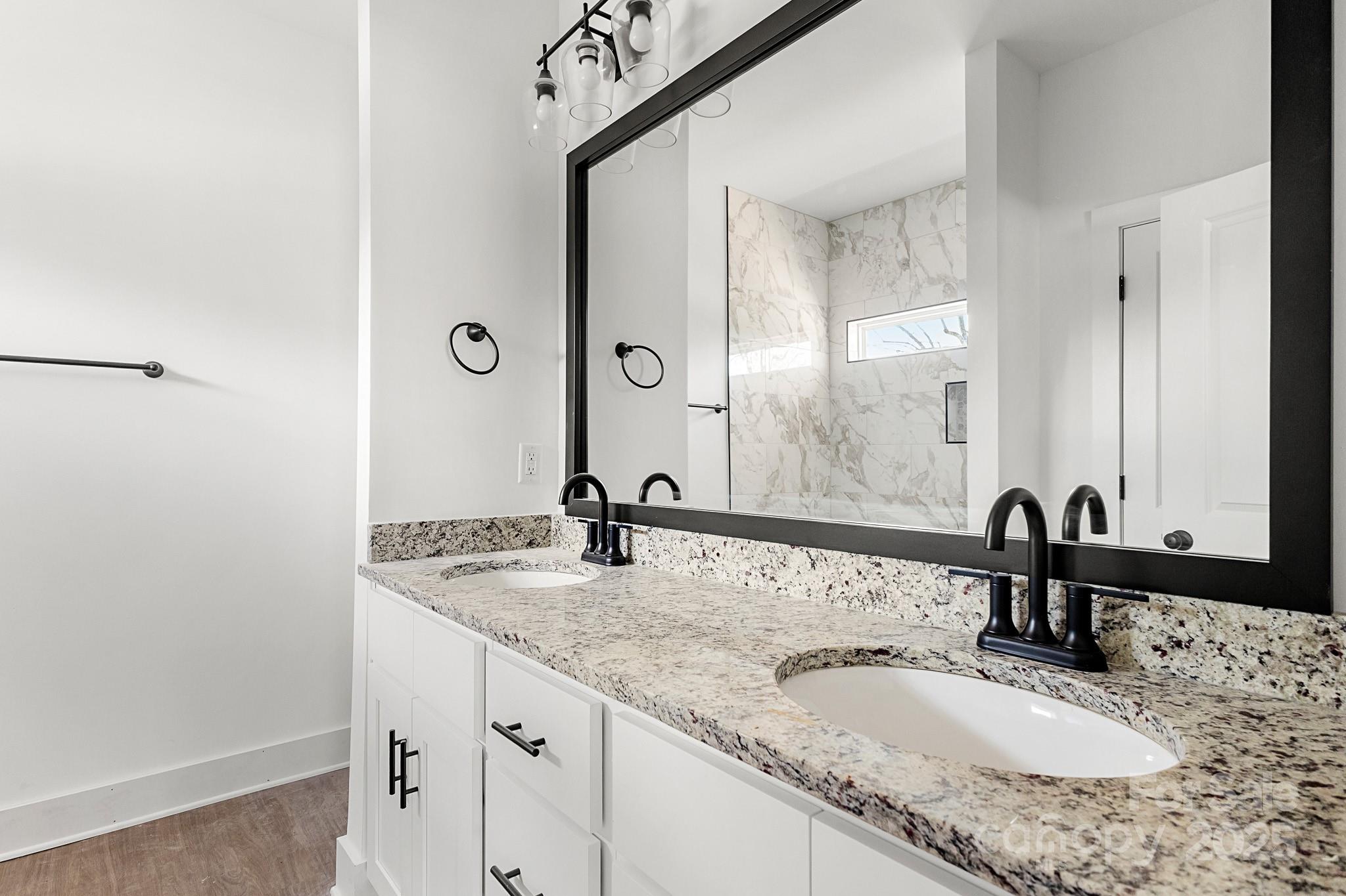 3309 Old Pageland Monroe Road Monroe, NC 28112 - Photo 16 of 37 a bathroom with a granite countertop sink and a mirror
