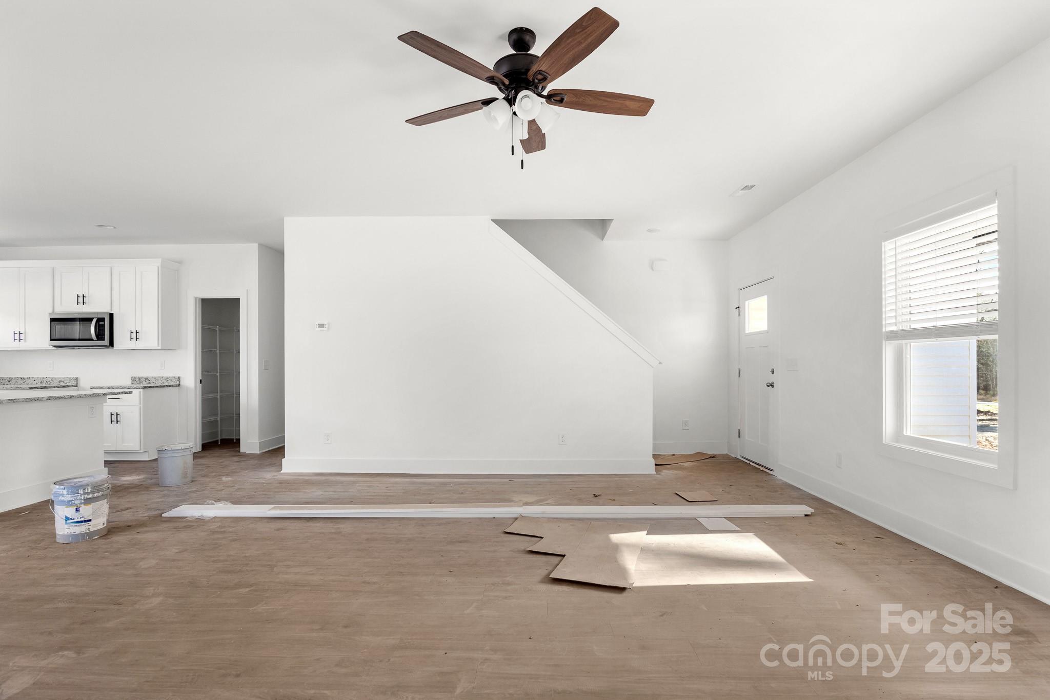 3309 Old Pageland Monroe Road Monroe, NC 28112 - Photo 19 of 37 an empty room with windows and ceiling fan
