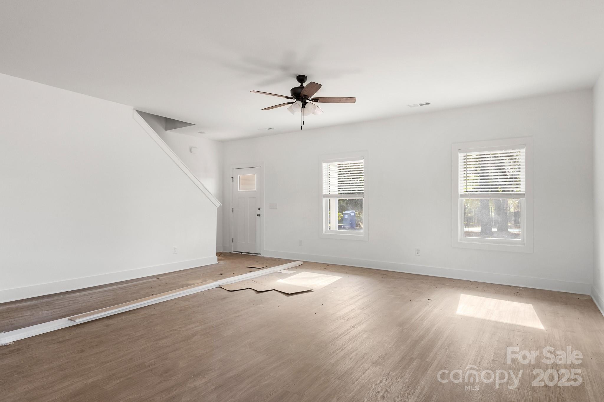 3309 Old Pageland Monroe Road Monroe, NC 28112 - Photo 2 of 37 an empty room with windows and ceiling fan