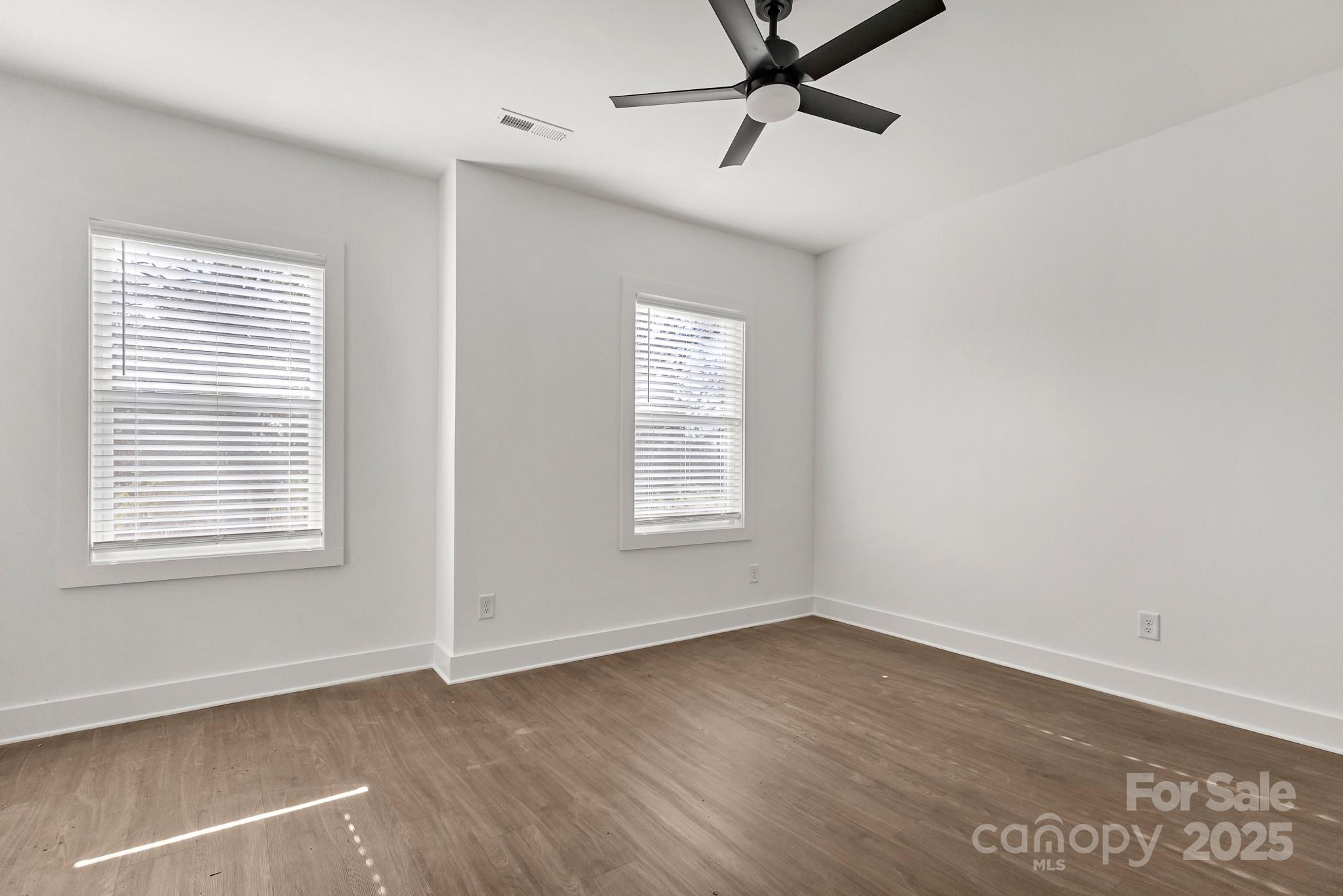 3309 Old Pageland Monroe Road Monroe, NC 28112 - Photo 22 of 37 a view of empty room with wooden floor and fan