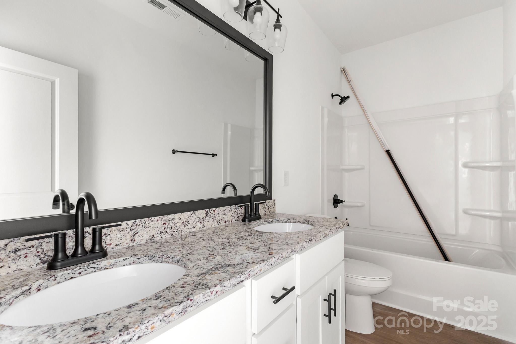 3309 Old Pageland Monroe Road Monroe, NC 28112 - Photo 25 of 37 a bathroom with a granite countertop sink and a mirror
