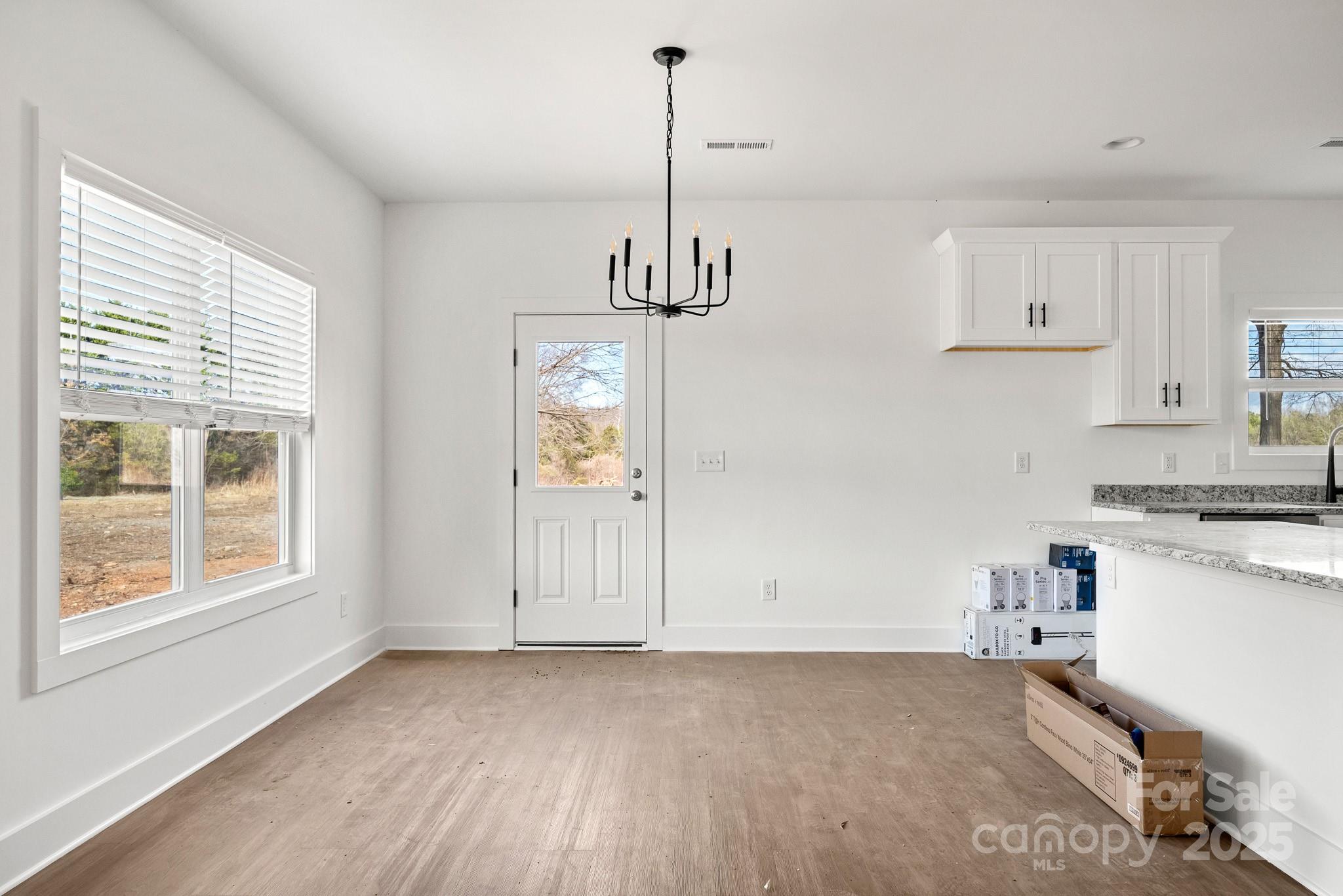 3309 Old Pageland Monroe Road Monroe, NC 28112 - Photo 7 of 37 a view of an empty room with a window and kitchen view