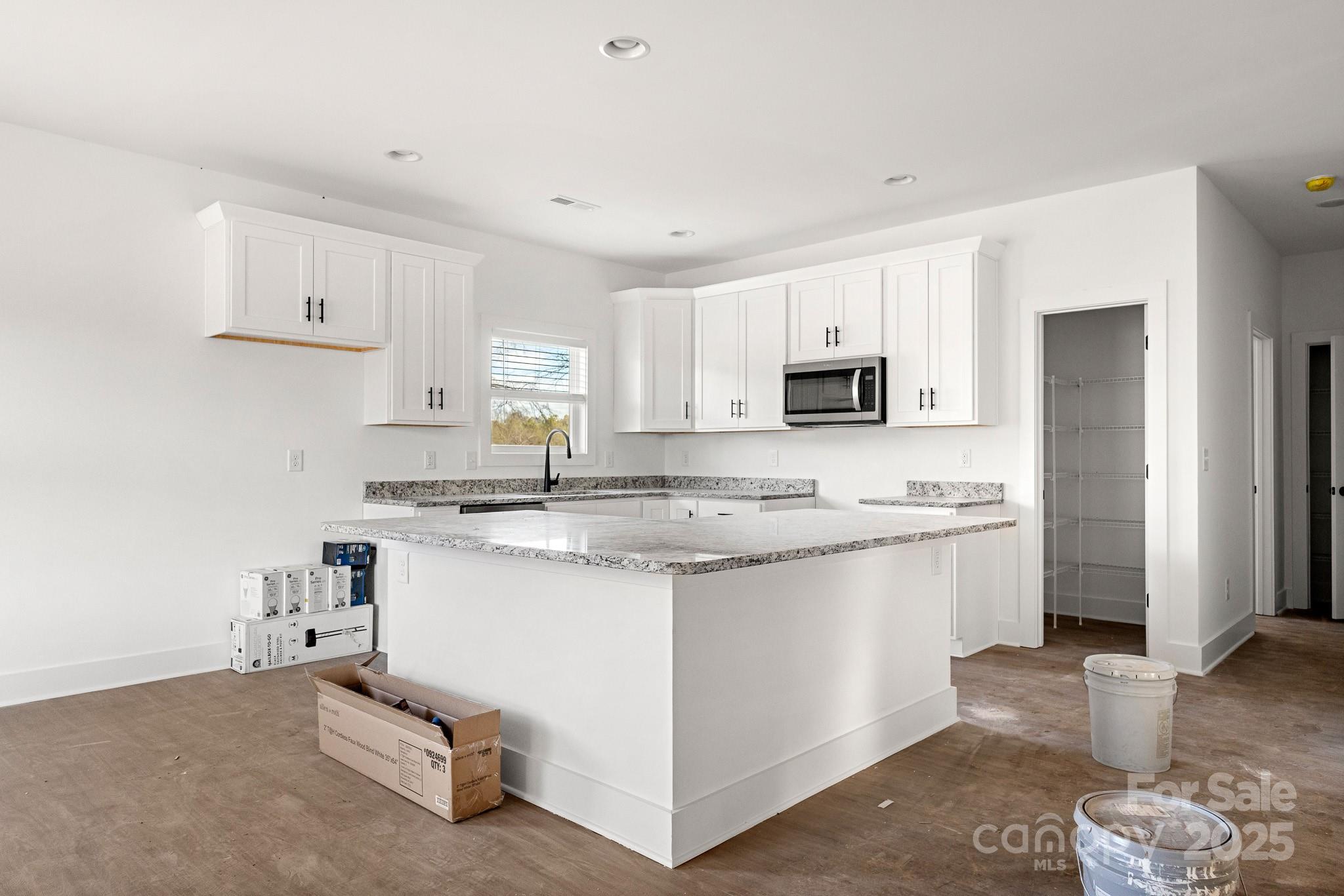 3309 Old Pageland Monroe Road Monroe, NC 28112 - Photo 8 of 37 a kitchen with granite countertop a sink stove and refrigerator