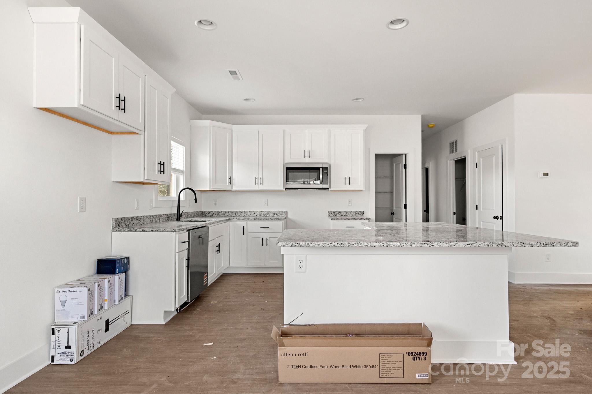 3309 Old Pageland Monroe Road Monroe, NC 28112 - Photo 9 of 37 a kitchen with stainless steel appliances granite countertop a sink and a stove
