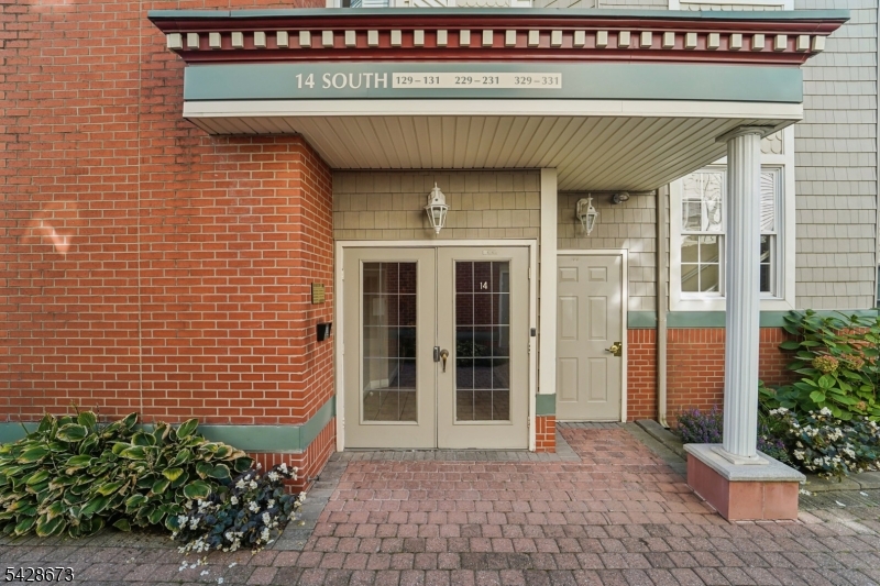 129 The Promenade Edgewater, NJ 07020 - Photo 16 of 17 a front view of a house with a garden