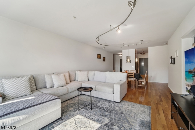 129 The Promenade Edgewater, NJ 07020 - Photo 3 of 17 a living room with furniture and wooden floor