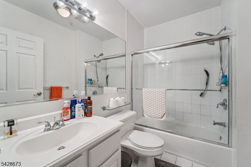 129 The Promenade Edgewater, NJ 07020 - Photo 8 of 17 a bathroom with a sink toilet and shower