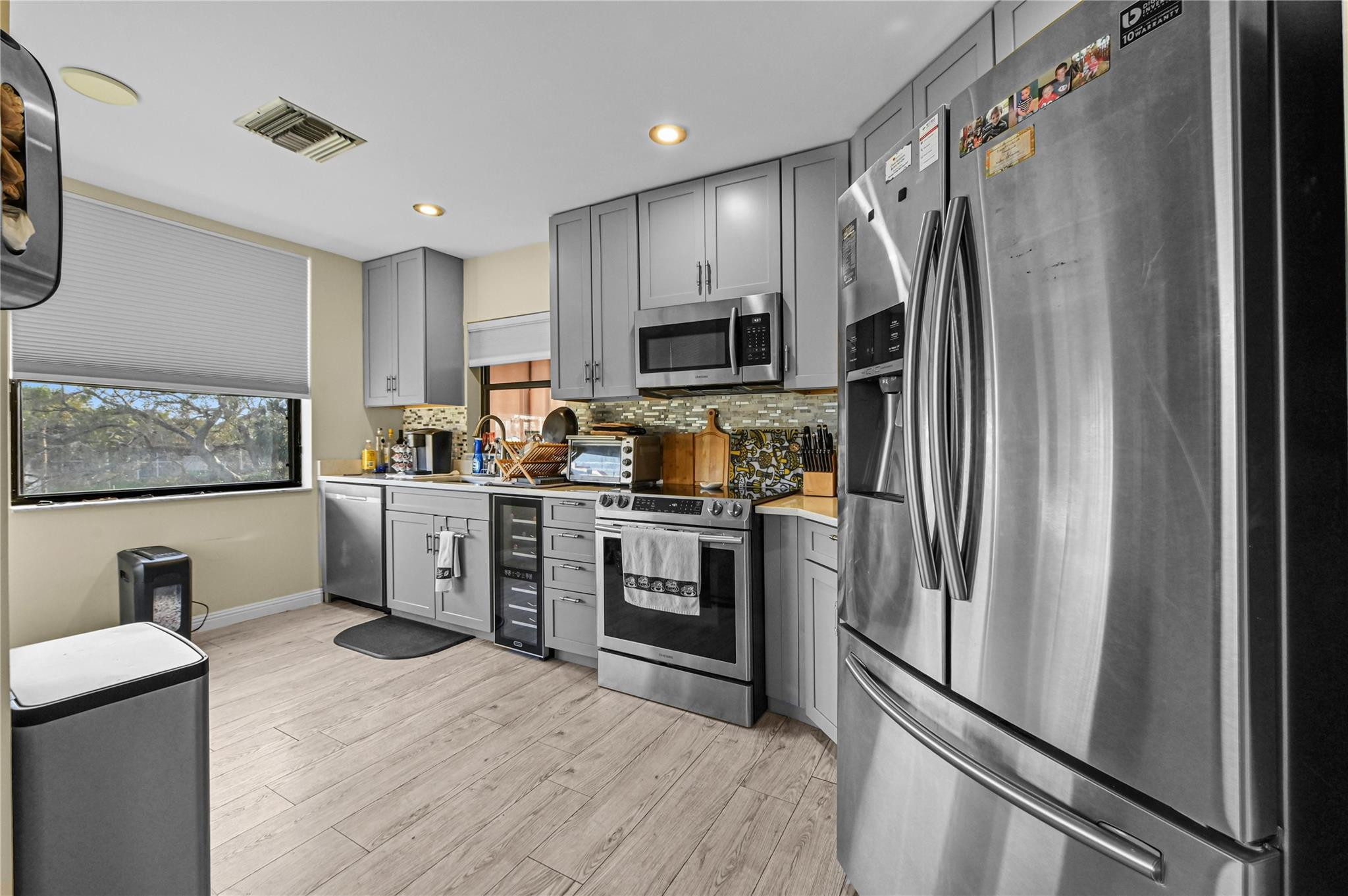 7520 La Paz Boulevard, Unit 306 Boca Raton, FL 33433 - Photo 17 of 36 a kitchen with stainless steel appliances a refrigerator sink and microwave