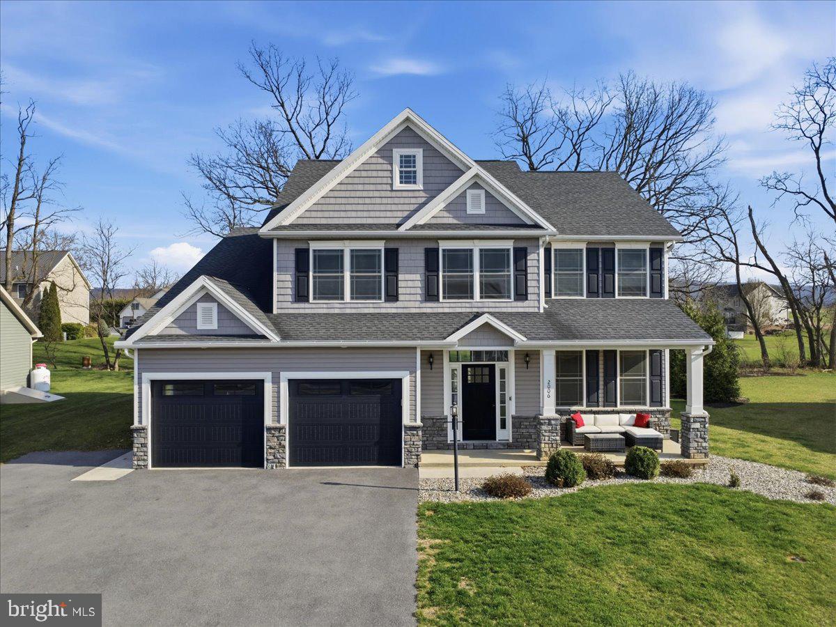 a front view of a house with a yard table and chairs