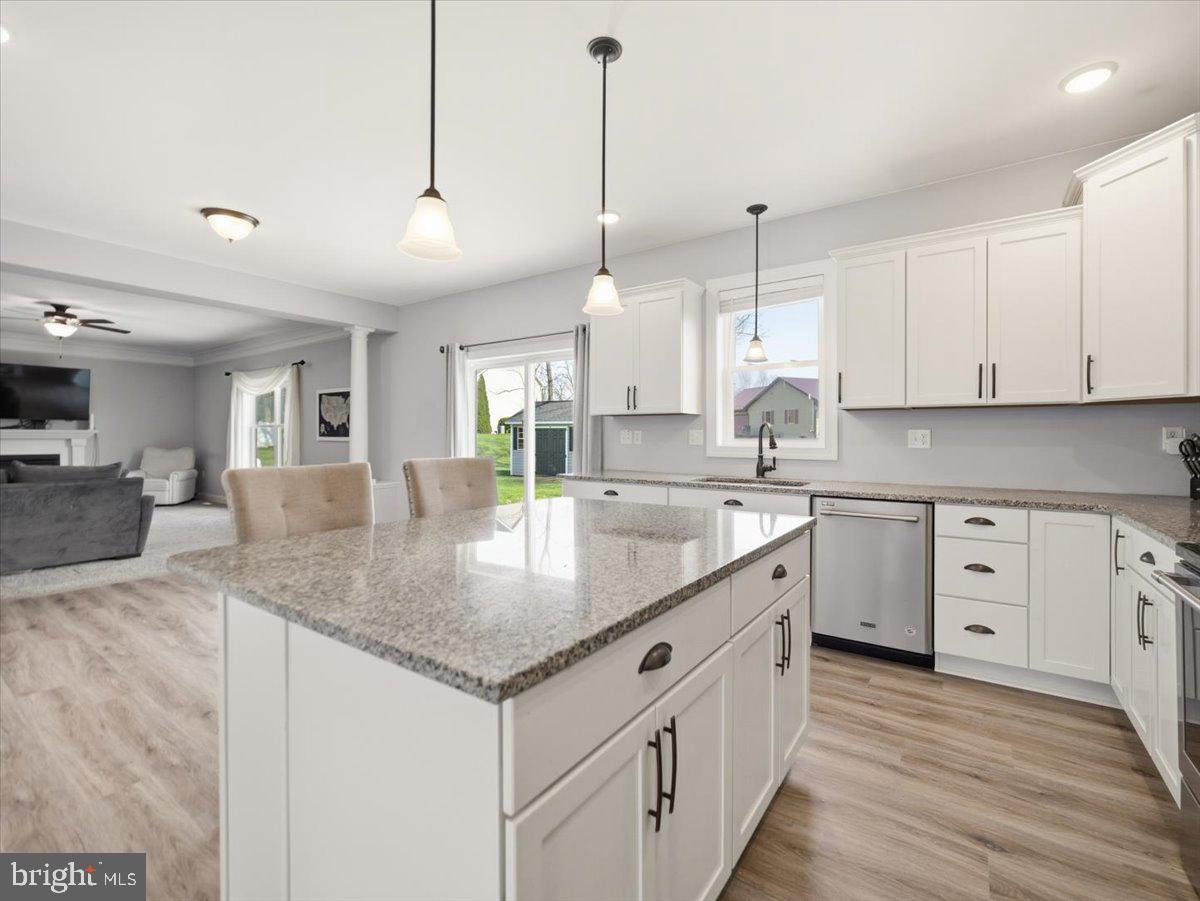 2006 Jelena Road Shippensburg, PA 17257 - Photo 13 of 47 a kitchen with stainless steel appliances granite countertop a sink a oven a dining table and chairs with wooden floor