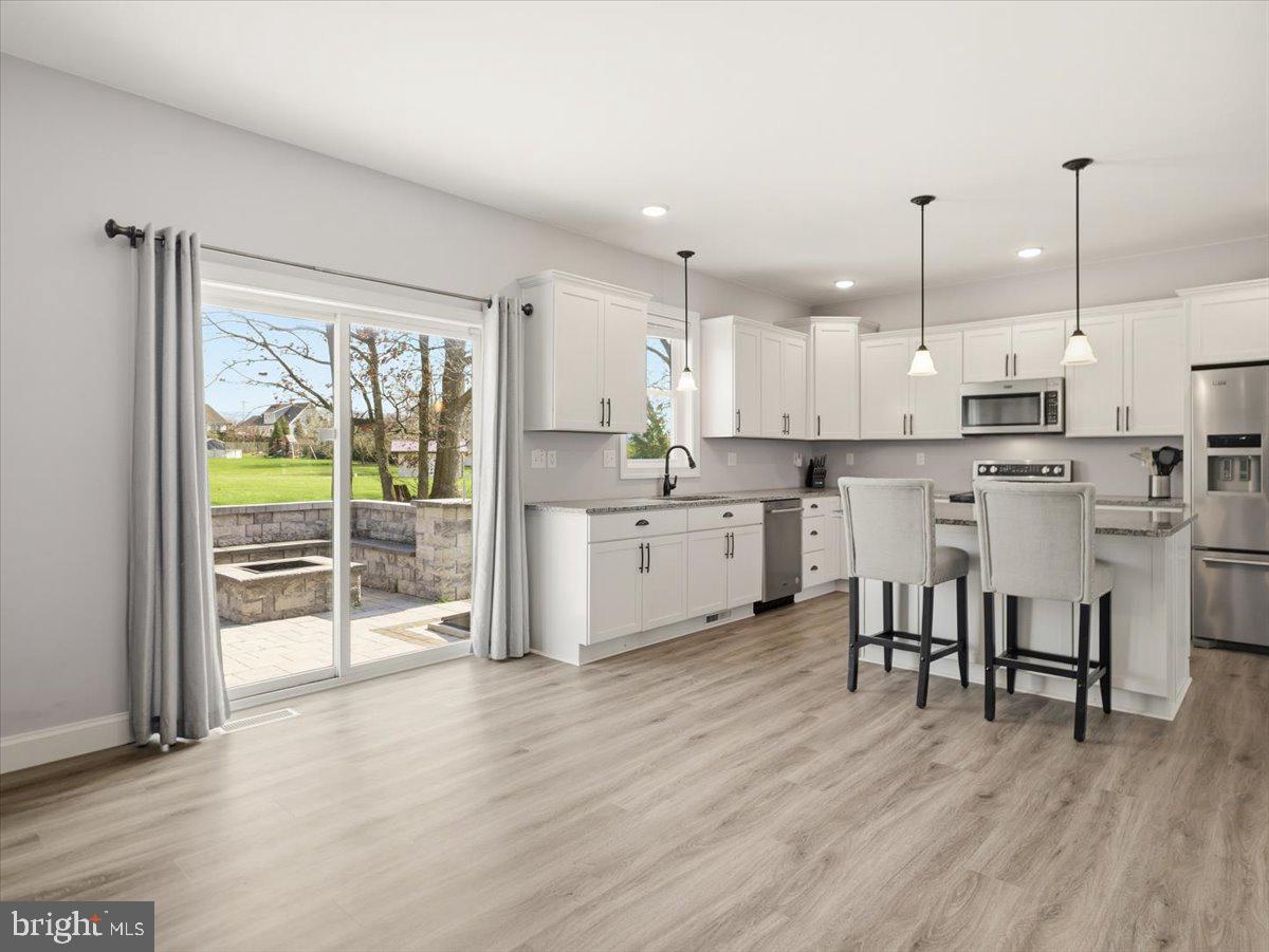2006 Jelena Road Shippensburg, PA 17257 - Photo 15 of 47 a kitchen with stainless steel appliances a table chairs refrigerator and cabinets