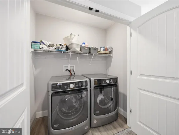 a utility room with sink dryer and washer
