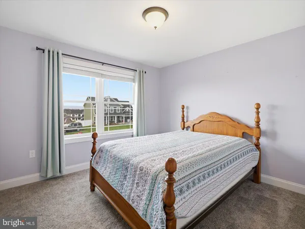 a bed sitting in a bedroom next to a window