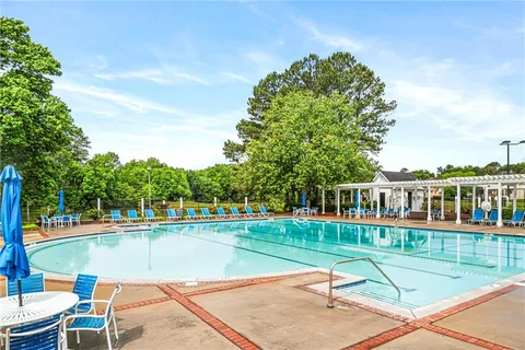 a view of a swimming pool with a lounge chair