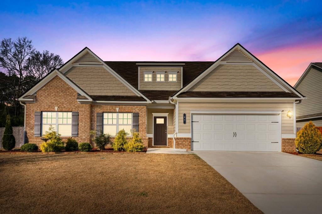 62 Flower Petal Way Dacula, GA 30019 - Photo 1 of 1 a front view of a house with a yard and garage
