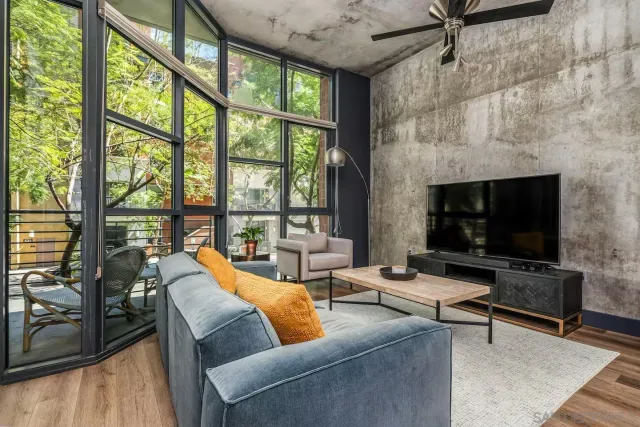 a living room with furniture tv and a fireplace