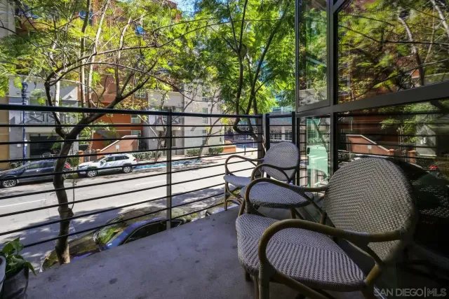 a view of a chairs and table in the back yard of the house
