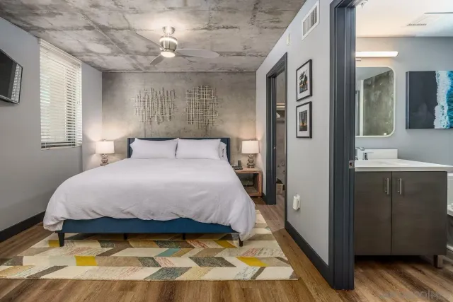 a bedroom with a bed and a mirror