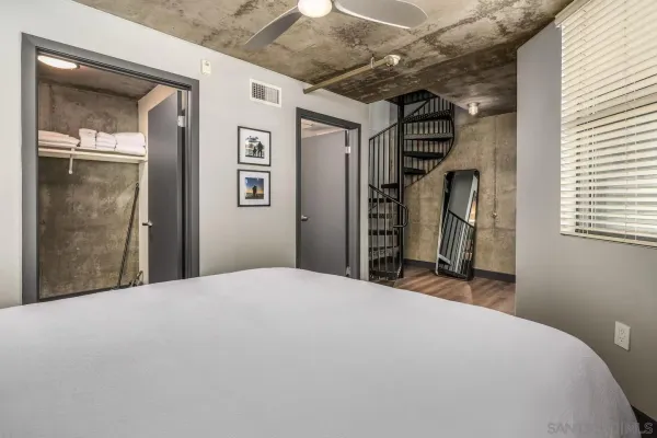 a bedroom with a bed and a mirror