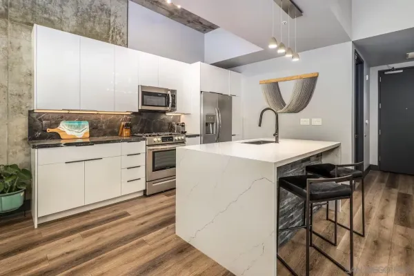 a kitchen with a sink stainless steel appliances and cabinets
