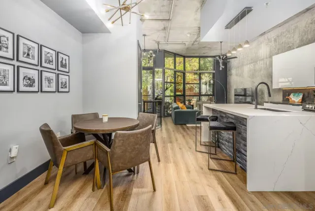 a view of a dining room with furniture and a large window