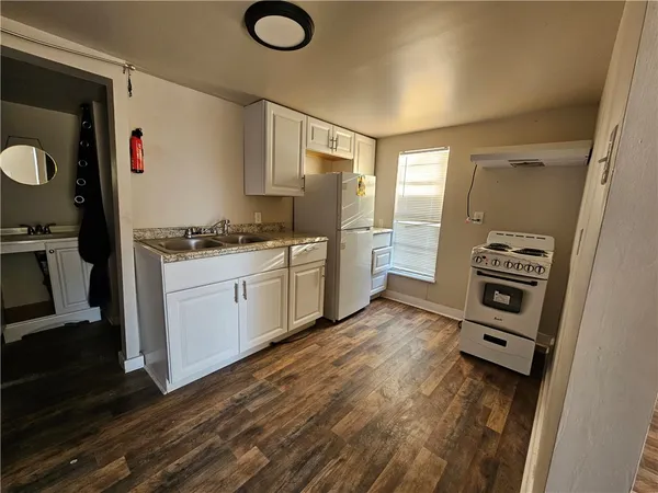 a kitchen with stainless steel appliances a stove a sink and a refrigerator
