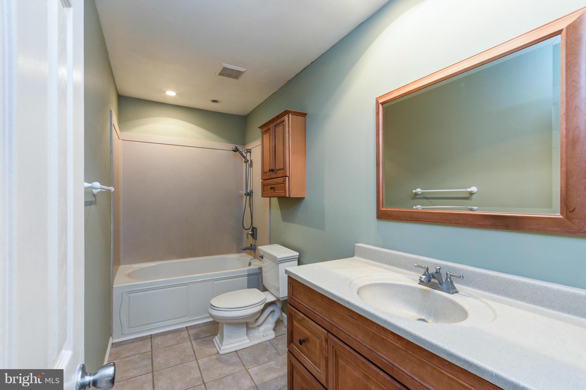 730 Rosewood Road Severn, MD 21144 - Photo 12 of 30 a bathroom with a granite countertop sink toilet and shower