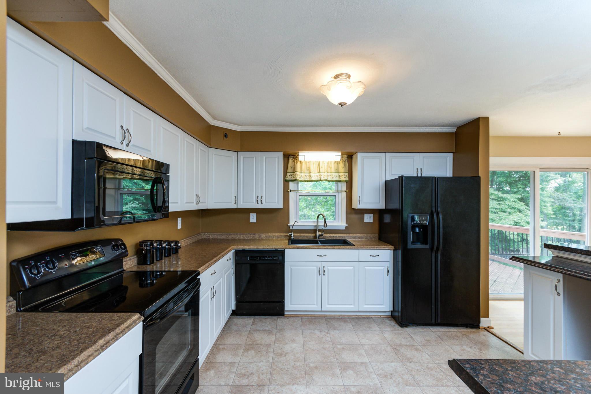 730 Rosewood Road Severn, MD 21144 - Photo 6 of 30 a kitchen with granite countertop a refrigerator stove top oven and sink