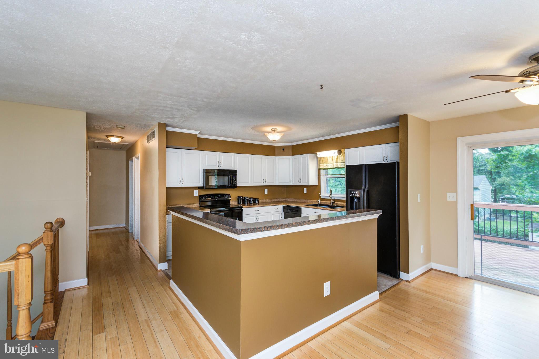 730 Rosewood Road Severn, MD 21144 - Photo 8 of 30 a kitchen with a stove a refrigerator and wooden floor