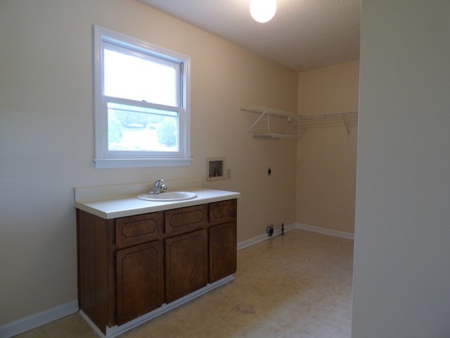 4628 Jones Road Macon, GA 31216 - Photo 11 of 25 a bathroom with a sink toilet and window
