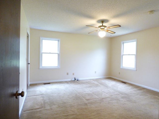 4628 Jones Road Macon, GA 31216 - Photo 13 of 25 an empty room with windows and fan