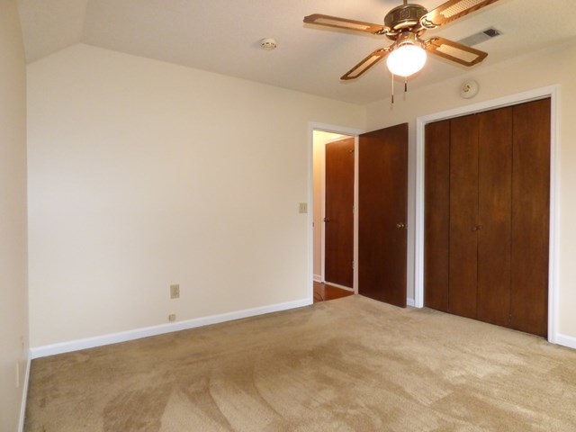4628 Jones Road Macon, GA 31216 - Photo 18 of 25 an empty room with a chandelier fan and closet