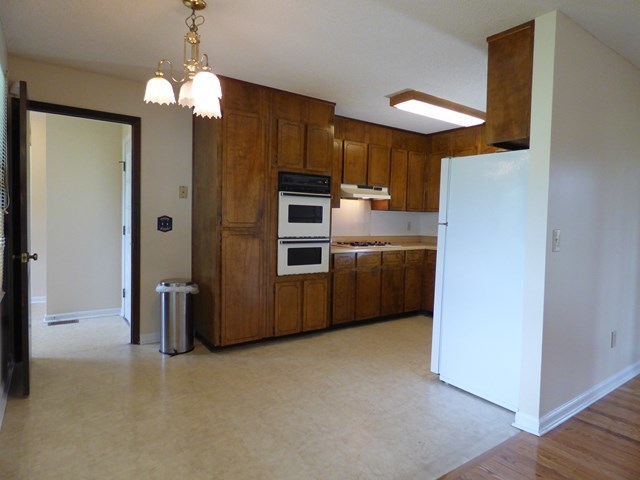 4628 Jones Road Macon, GA 31216 - Photo 8 of 25 a kitchen with stainless steel appliances a refrigerator and a chandelier