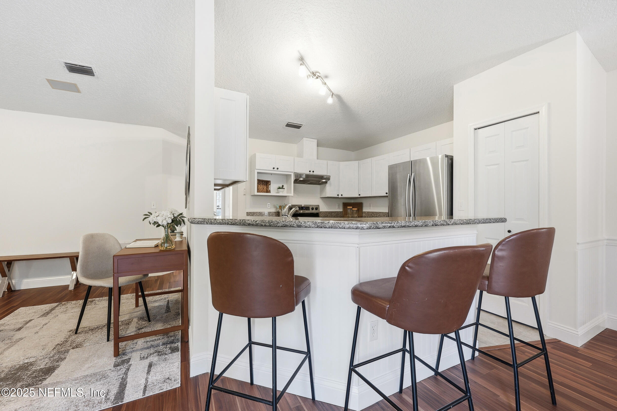 1626 Sandy Hollow Loop Middleburg, FL 32068 - Photo 11 of 40 a kitchen with stainless steel appliances granite countertop a table chairs and a refrigerator