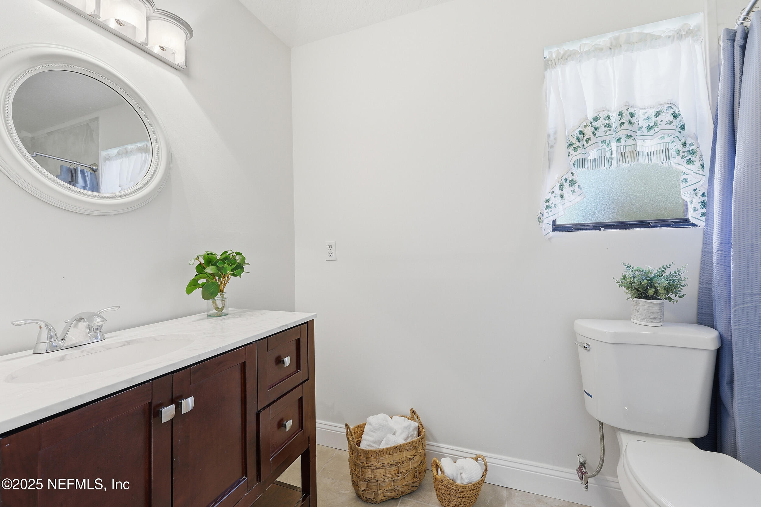 1626 Sandy Hollow Loop Middleburg, FL 32068 - Photo 15 of 40 a bathroom with a sink mirror vanity and toilet