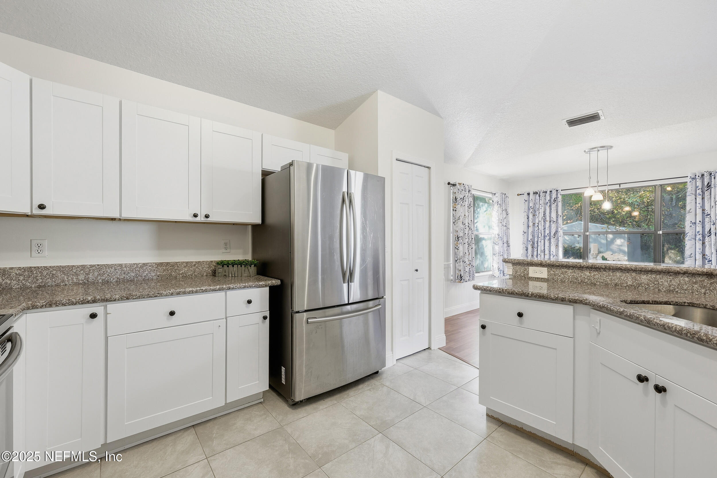1626 Sandy Hollow Loop Middleburg, FL 32068 - Photo 2 of 40 a kitchen with white cabinets and refrigerator