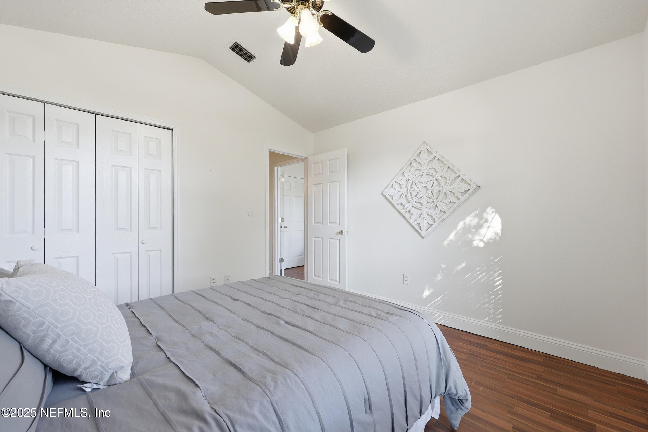 1626 Sandy Hollow Loop Middleburg, FL 32068 - Photo 22 of 40 a bedroom with a bed and chandelier