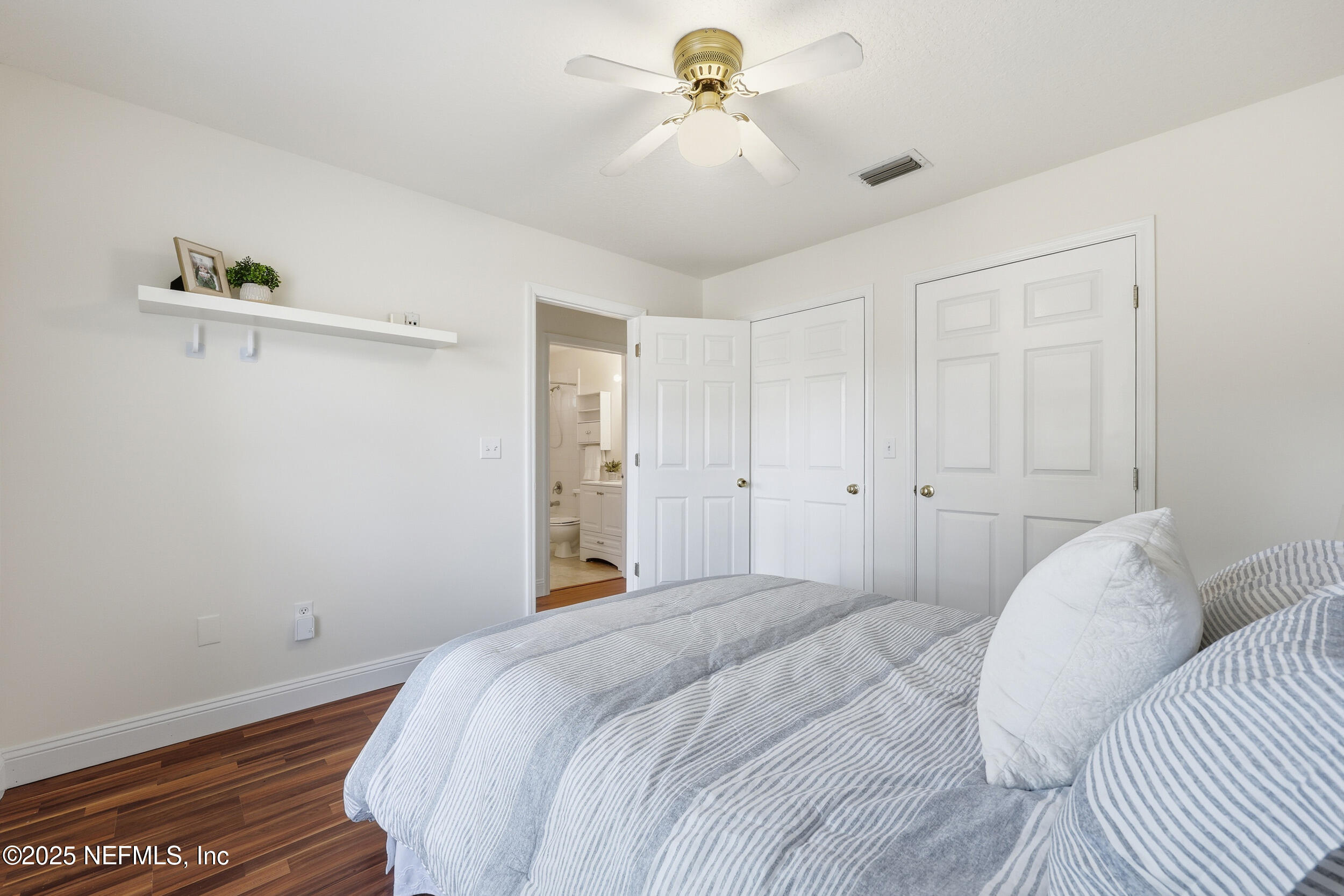 1626 Sandy Hollow Loop Middleburg, FL 32068 - Photo 25 of 40 a bedroom with a bed and a chandelier