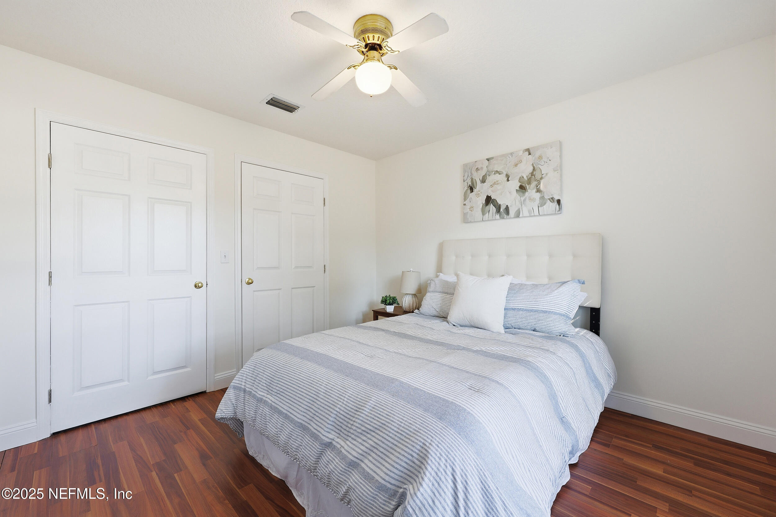 1626 Sandy Hollow Loop Middleburg, FL 32068 - Photo 26 of 40 a bedroom with a bed and a chandelier