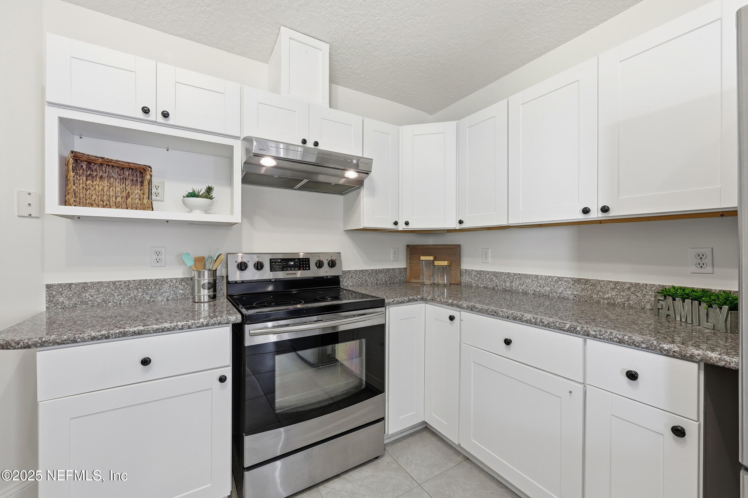 1626 Sandy Hollow Loop Middleburg, FL 32068 - Photo 7 of 40 a kitchen with granite countertop white cabinets and stainless steel appliances