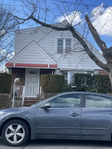 a view of a car parked in front of a house